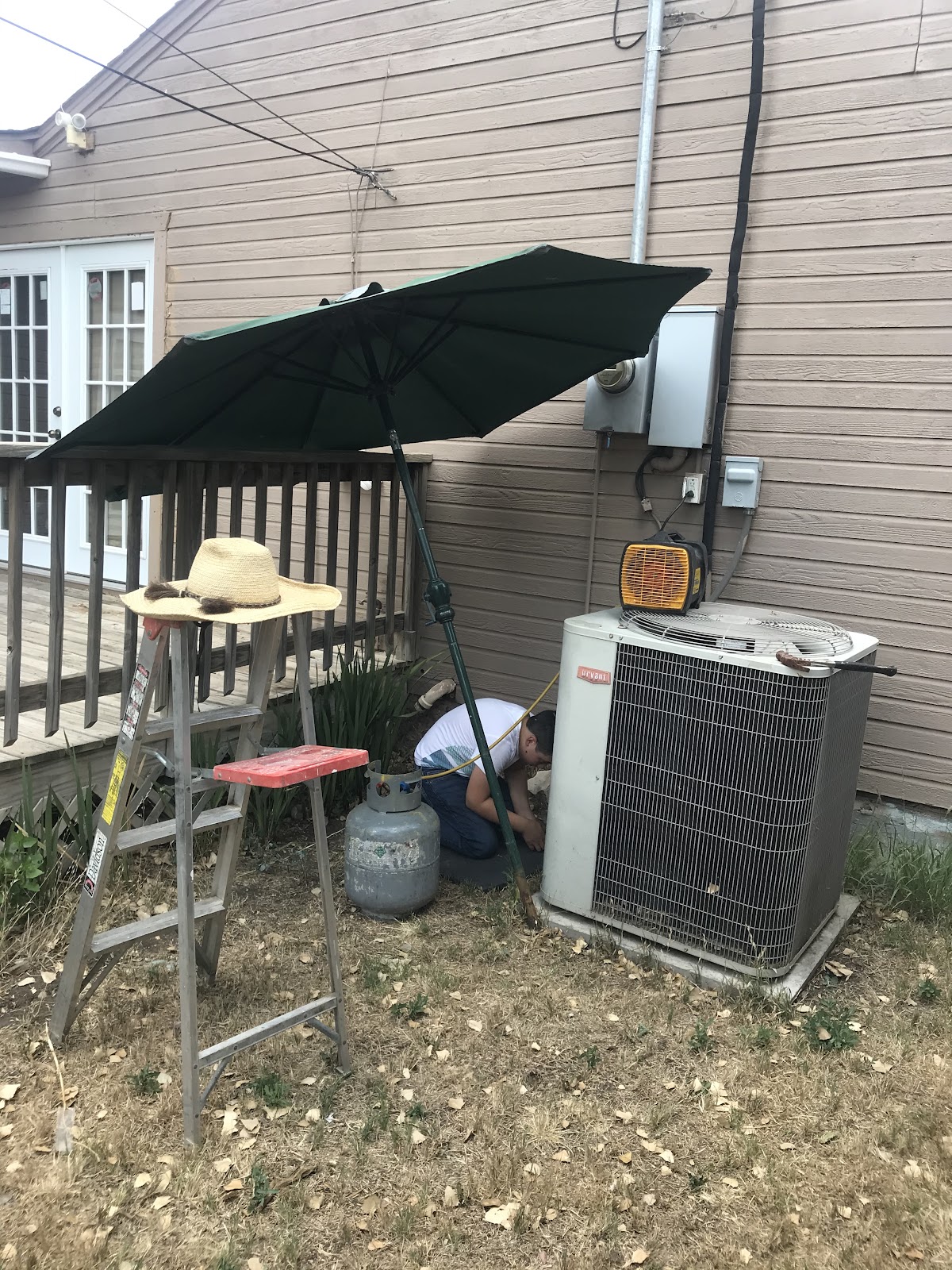 HVAC technician working on outdoor condenser